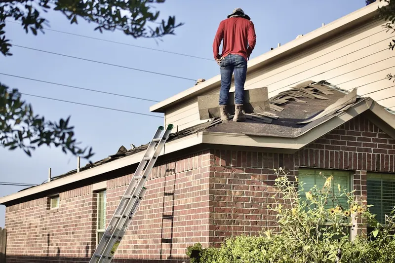 Professional roofer working on a residential roof in Wolfs Store